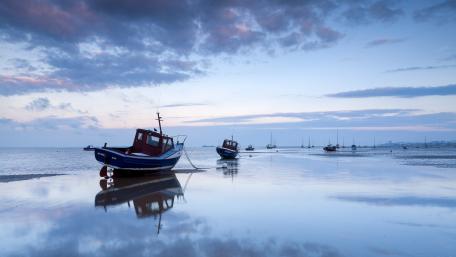 Serene Boats at Dusk on Tranquil Waters wallpaper
