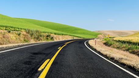 Breathtaking Curvy Road Through Rolling Hills wallpaper