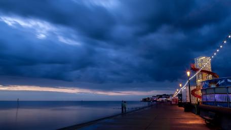 Serene Dusk Over a Coastal City Scene wallpaper