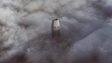 Mystical Skyscraper Surrounded by Clouds wallpaper