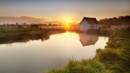 Serene Cottage Reflection at Sunrise wallpaper
