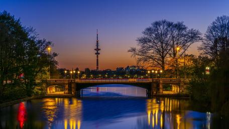 Cityscape at Dusk with River Reflection and Tower View wallpaper