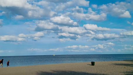 Serene Beach with Gentle Waves and Beautiful Clouds wallpaper