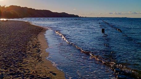 Serene Beach Sunset with Gentle Waves and Sand wallpaper
