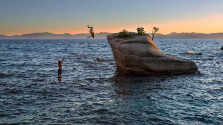 Adventurous Spirits at Sunset Over Water wallpaper