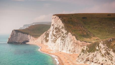 Majestic Cliffs and Serene Shoreline Views wallpaper