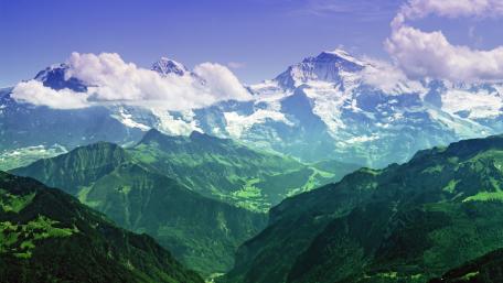Majestic Mountain Range Under Cloudy Skies wallpaper