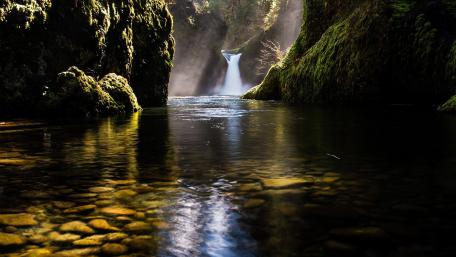 Serene Waterfall Amidst Lush Greenery wallpaper