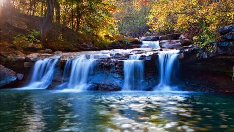 Serene Autumn Waterfall Scene wallpaper