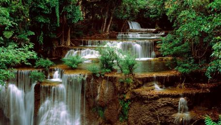 Serenity of Cascading Waterfalls in Lush Greenery wallpaper