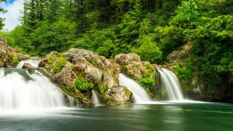 Serene Waters Cascading Down Rocks wallpaper