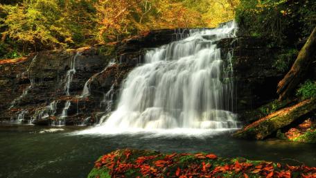 Serene Autumn Waterfall Scene wallpaper