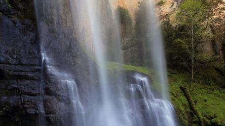 Majestic Waterfall Cascading Down Rock Face wallpaper