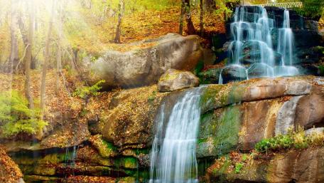 Serene Autumn Waterfall Scene wallpaper
