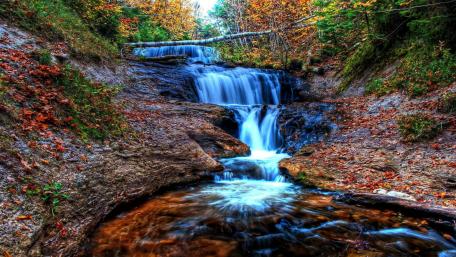 Serene Autumn Waterfall Scene wallpaper