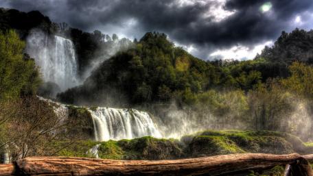 Majestic Waterfall Amidst Nature's Beauty wallpaper