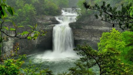 Majestic Waterfall in Serene Nature Scene wallpaper