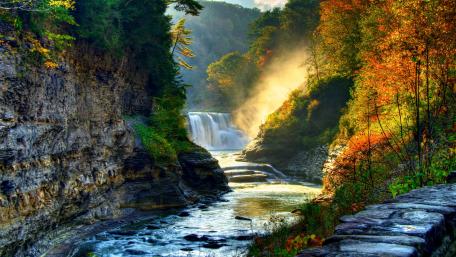 Majestic Waterfall in a Serene Landscape wallpaper