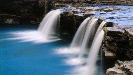Majestic Waterfalls in Tranquil Waters wallpaper