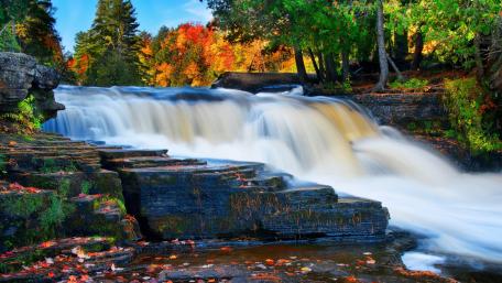 Serene Autumn Waterfall Scene wallpaper