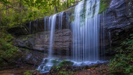 Serene Waterfall in Lush Green Landscape wallpaper