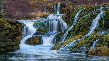 Majestic Waterfall in a Serene Landscape wallpaper