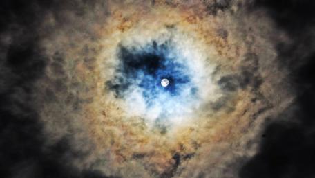 Mystical Full Moon Surrounded by Clouds in the Night Sky wallpaper