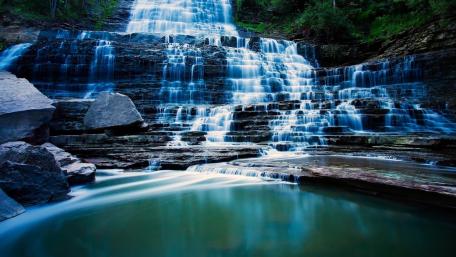 Serene Waterfall Cascade in Nature's Embrace wallpaper