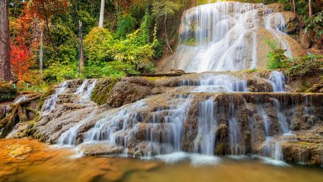 Majestic Waterfalls in a Lush Forest Scene wallpaper