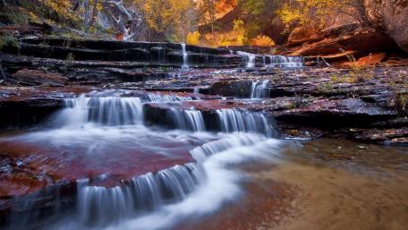 Serene Waterfalls in Autumn Landscape wallpaper