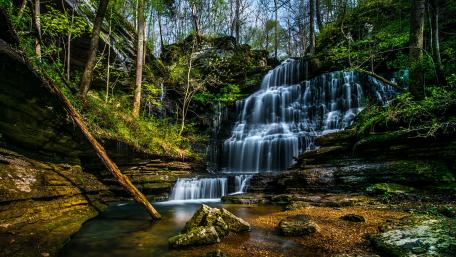 Serene Cascading Waterfall in Lush Forest Landscape wallpaper