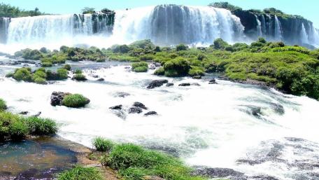 Majestic Waterfalls Surrounded by Lush Greenery wallpaper