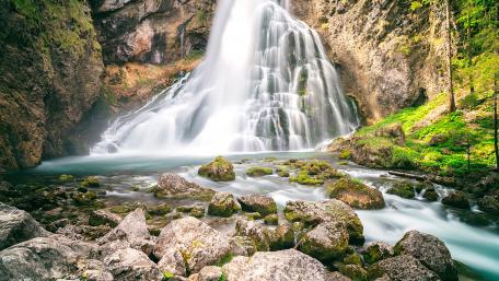 Majestic Waterfall in a Serene Landscape wallpaper