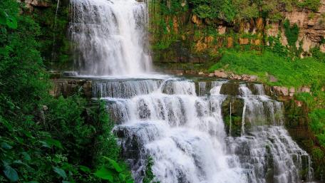 Majestic Waterfall Splashing into Nature's Embrace wallpaper