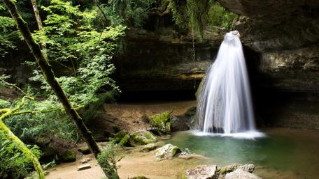 Serene Waterfall in Lush Green Forest wallpaper