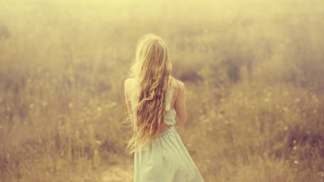 Lone girl in a field wallpaper