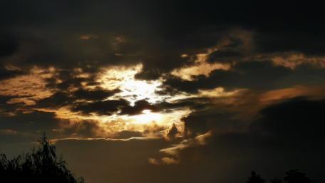 Dramatic Sunset Over Cloudy Skies wallpaper
