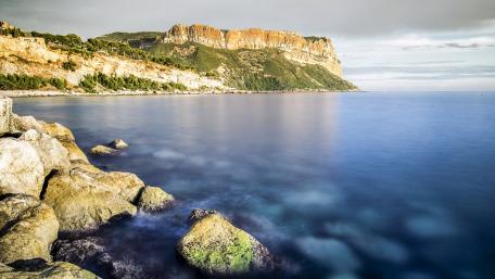 Serene Coastal Landscape with Cliffs and Calm Waters wallpaper