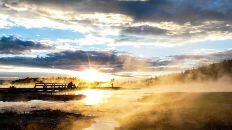 Majestic Sunrise Over Misty Landscape wallpaper
