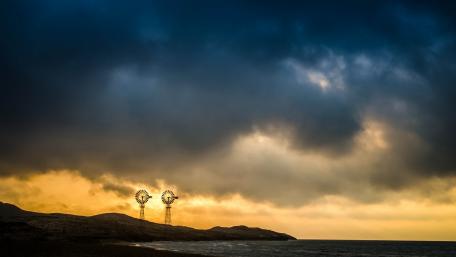 Majestic Windmills Against Stormy Sky wallpaper