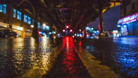 City Lights Reflected on Wet Streets at Midnight wallpaper