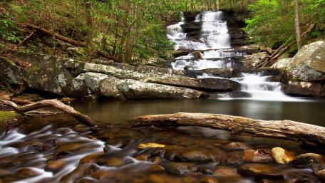 Tranquil Waterfalls Amidst Lush Greenery wallpaper