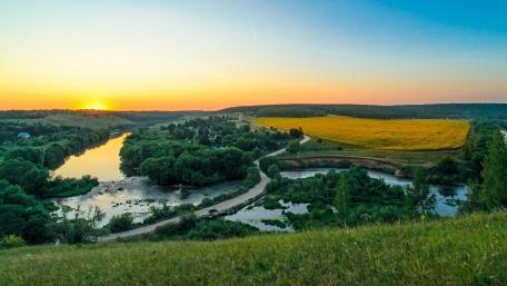 Serene Sunset Over Tranquil River Landscape wallpaper