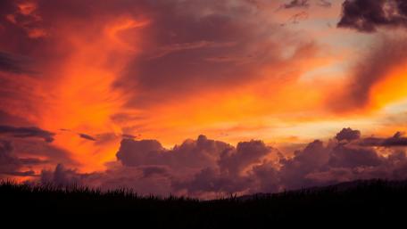 Fiery Sunset Over Cloudy Horizon wallpaper