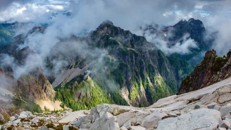 Majestic Mountains Shrouded In Misty Clouds wallpaper