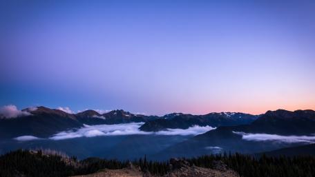 Serene Mountain Sunrise Over Misty Valleys wallpaper