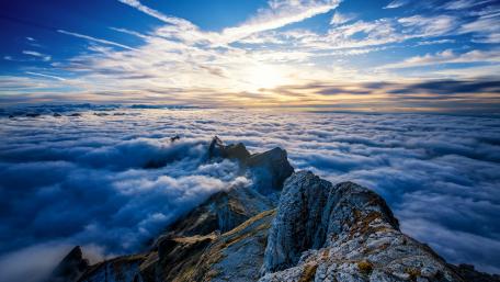Majestic Clouds Above Mountain Peaks wallpaper
