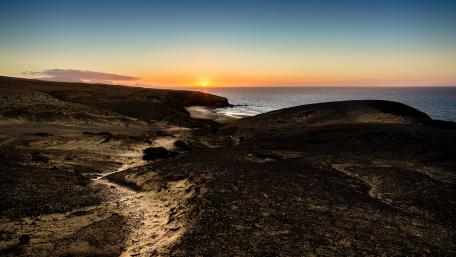 Majestic Coastal Sunset Over Serene Landscape wallpaper