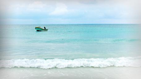 Serenity at Sea with a Lonely Boat wallpaper