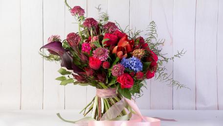 Vibrant Floral Bouquet on Rustic Wood Background wallpaper